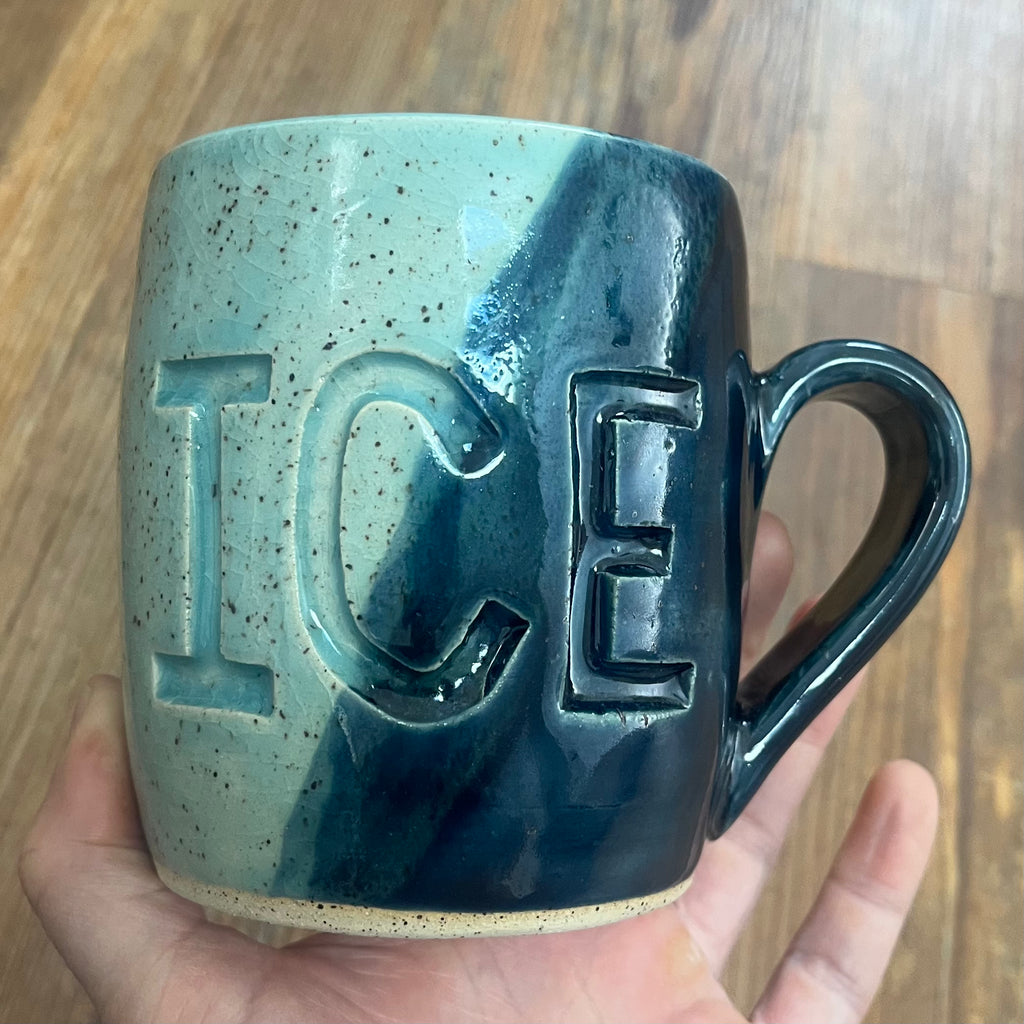 light and dark blue mug with fuck ice carved into it