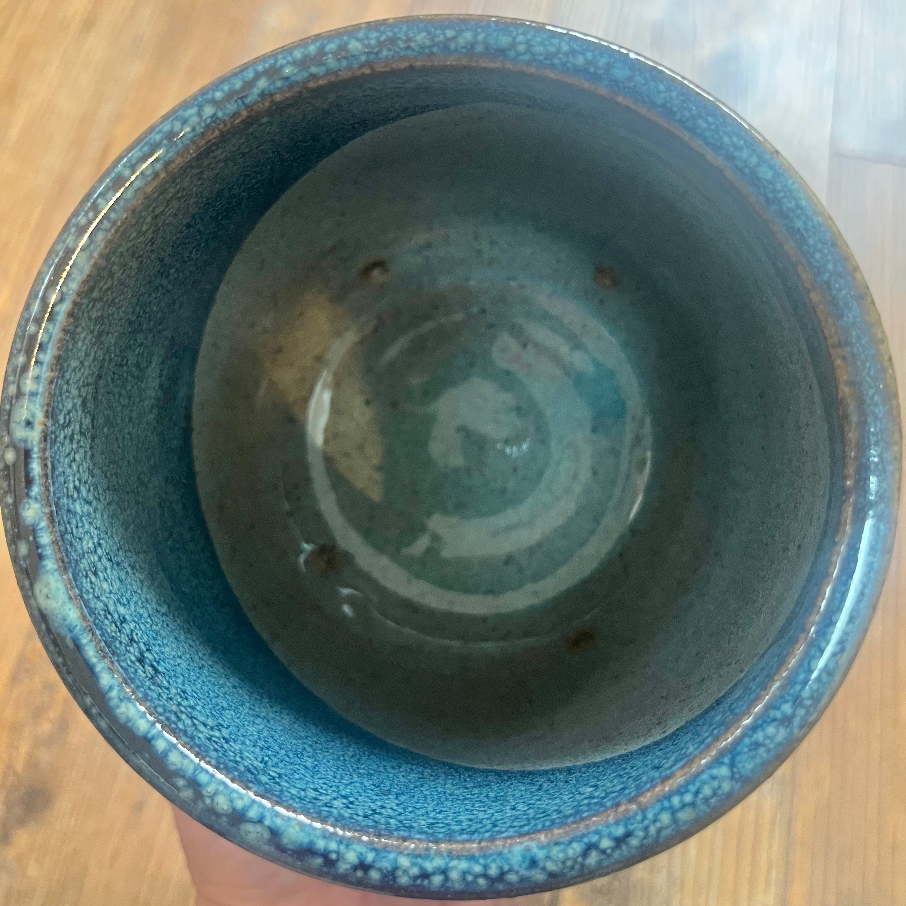 The inside of a planter with dark and light blue glaze