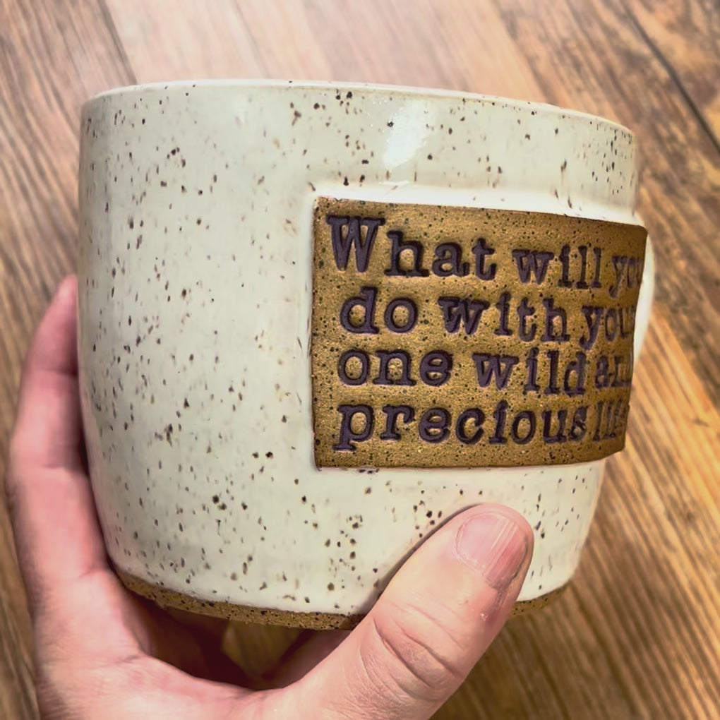 A video rotating around a white mug with purple text reading "What will you do with your one wild and precious life?"