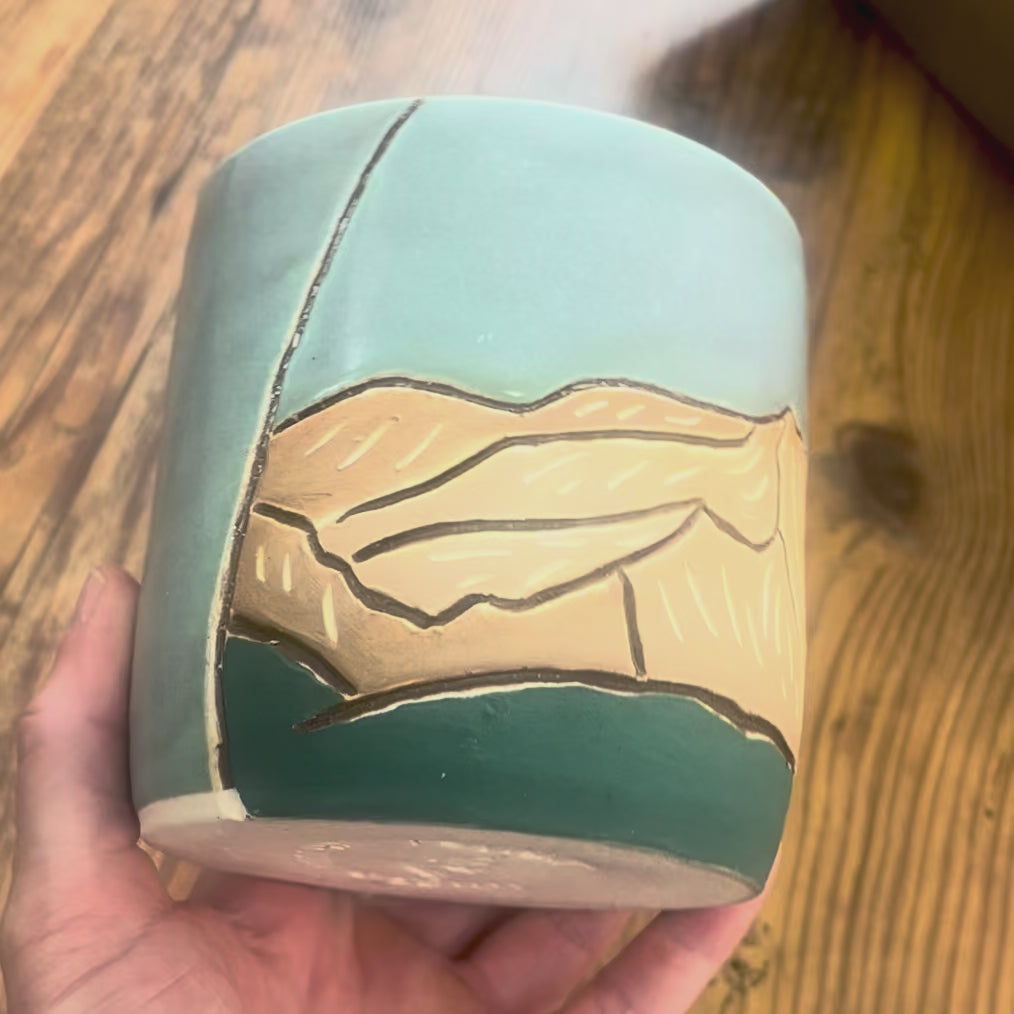 A video showing a mug with Mount Columbia, a Colorado 14er, carved on the mug
