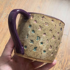 A video rotating around a mug with "take the fucking leap" stamped in diagonal stripes with a purple handle