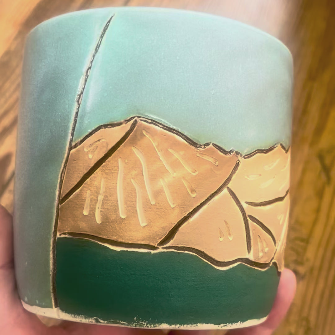 A video showing a mug with Mount Massive, a Colorado 14er, carved on the mug