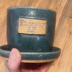 A video showing a greenish blue planter labeled with "Thirsty AF"