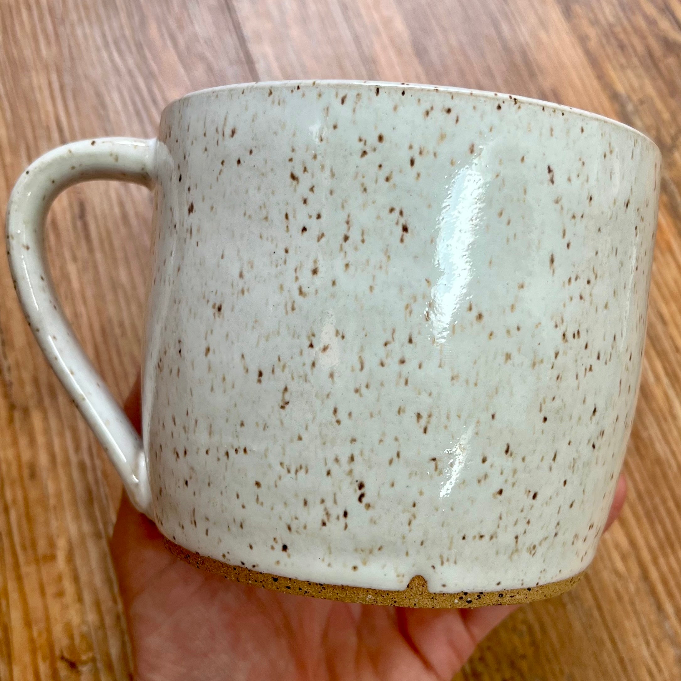 A white mug with brown speckles